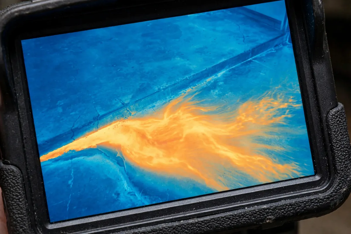 Thermal camera image showing a warm plume spreading across a slab floor